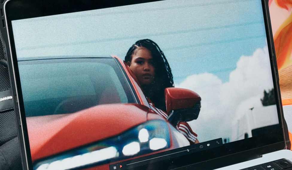 Woman looking out of a red car window